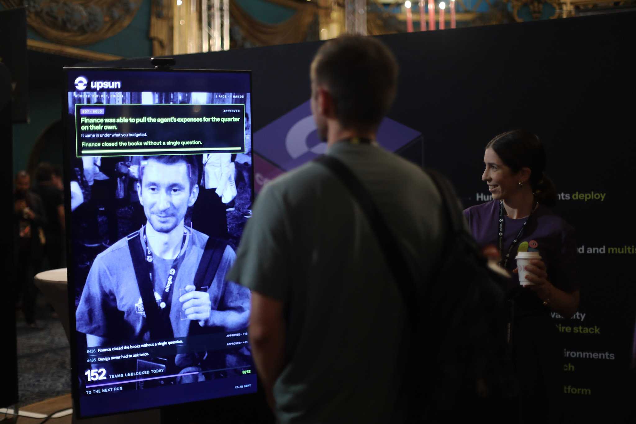 Upsun booth : visitor facing a gesture controlled Upsun screen