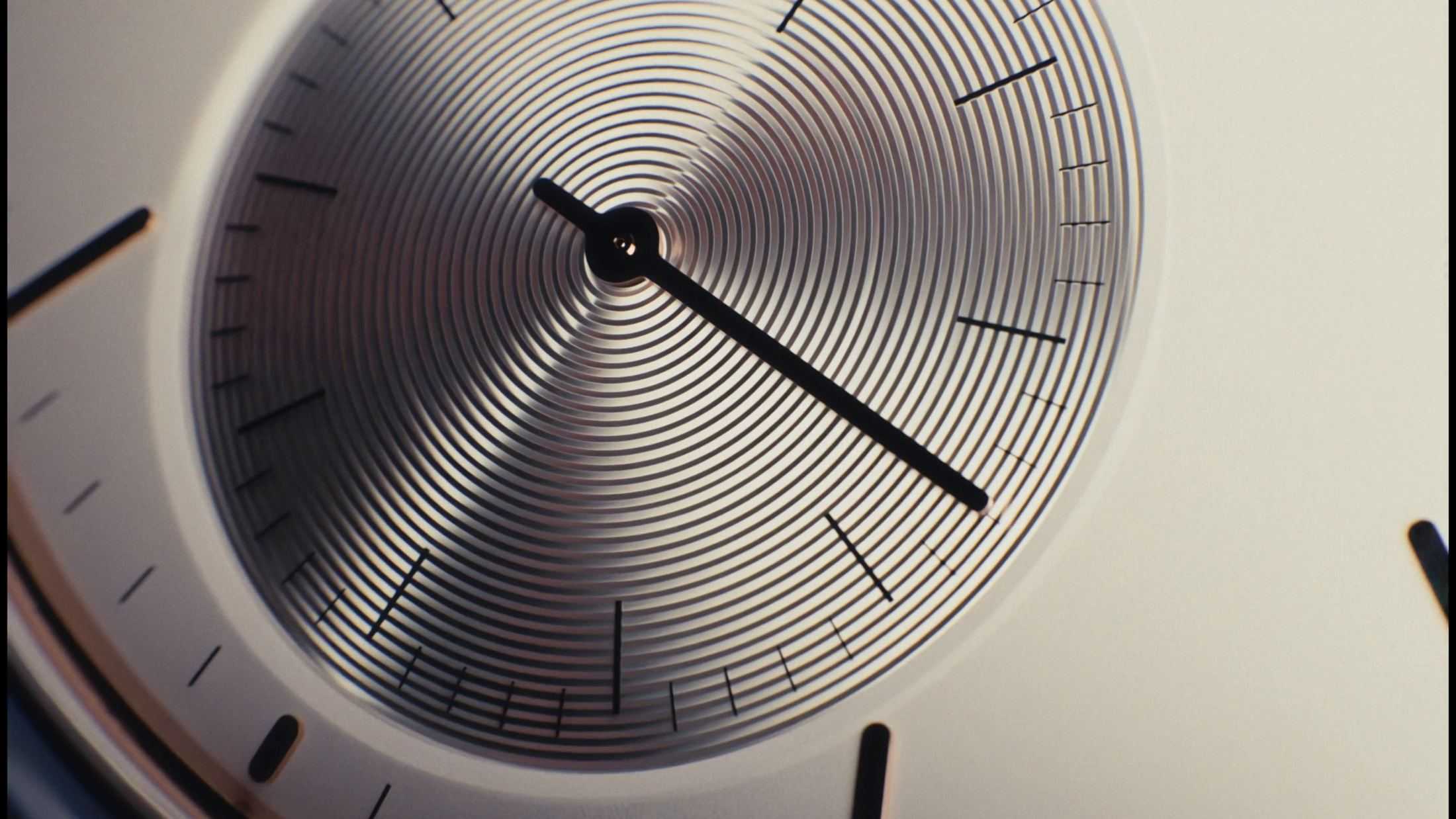 Close-up of the guilloché sub-dial of the white Withings watch and its black hand