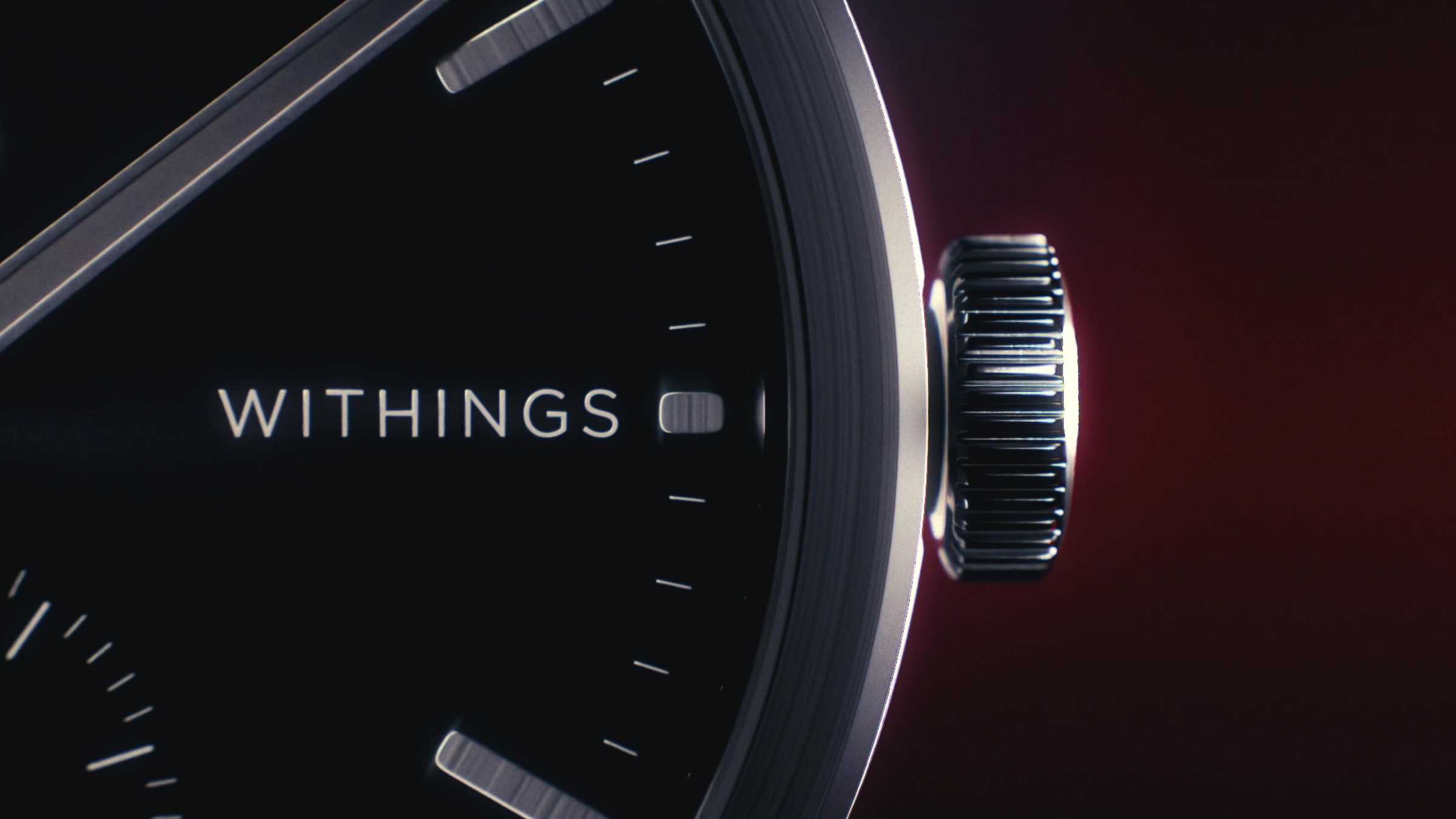 Close-up of the black dial and crown of a Withings watch