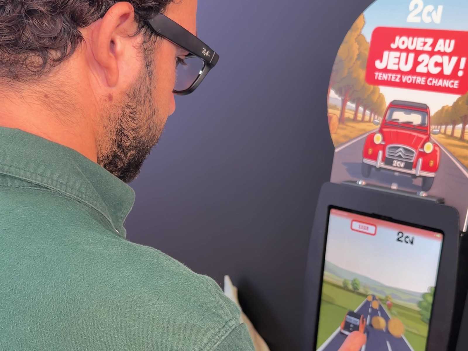 A visitor plays the 2CV game on the Citroën booth kiosk