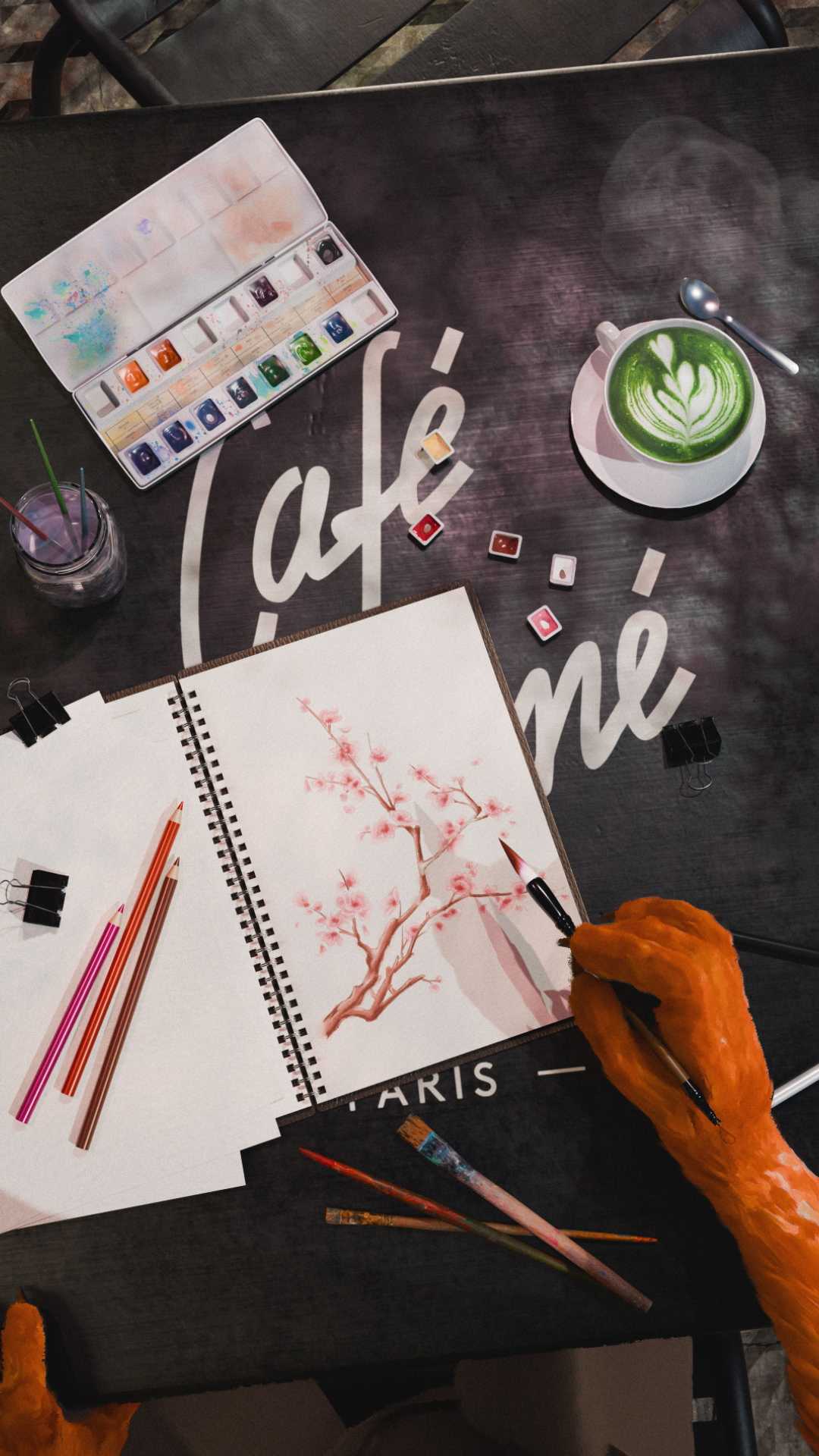 Café Kitsune. Kitsune painting Sakura. Watercolor. Hand close-up.